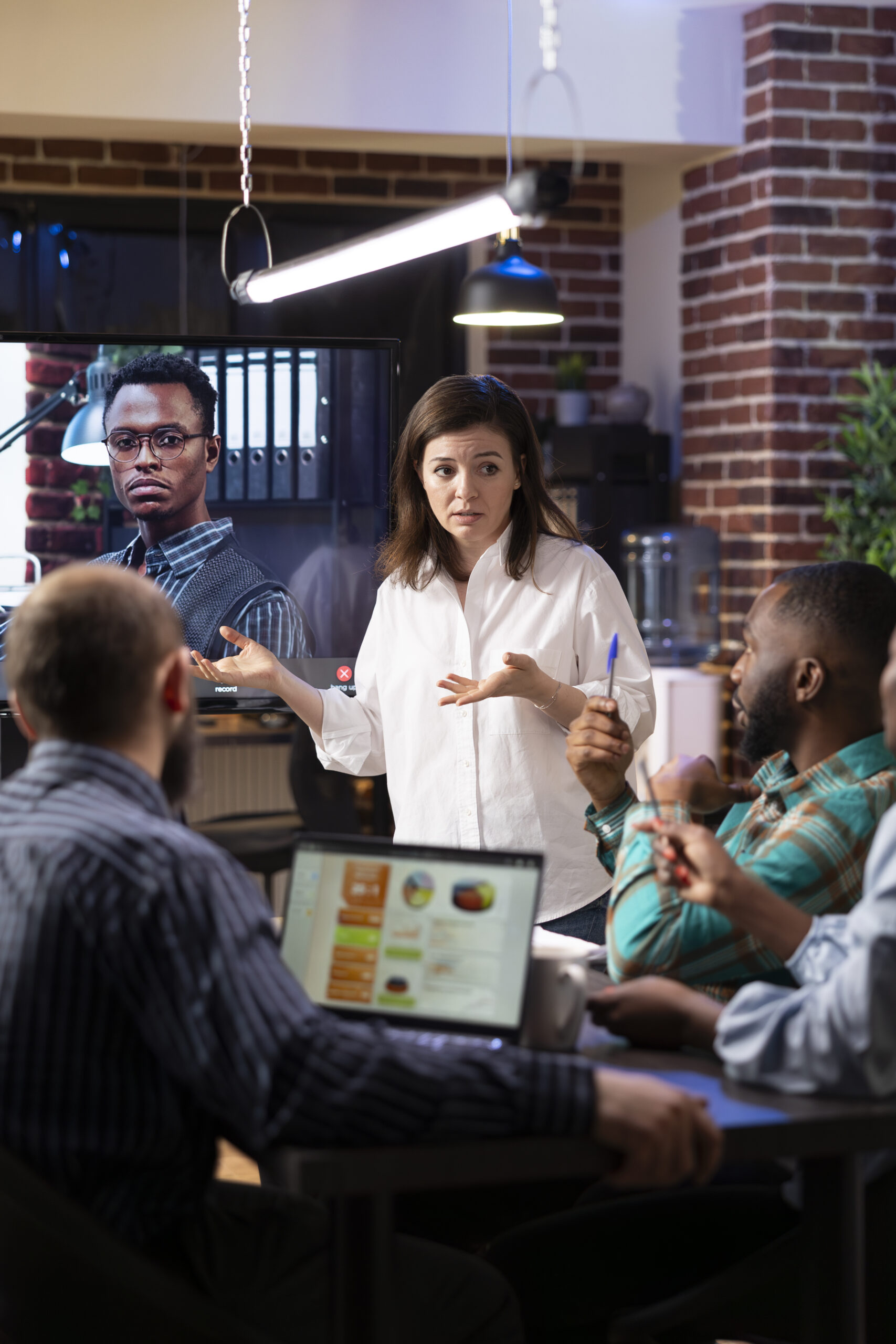 coworkers engaged in virtual meeting in office